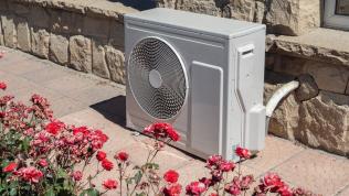 An air source heat pump attached to an attractive home