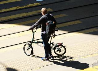 Man with a fold up bike