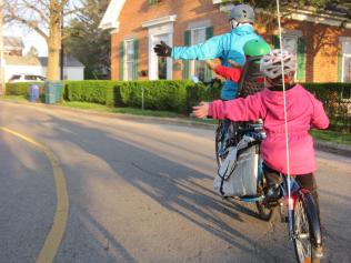 children cycling to school with guardian