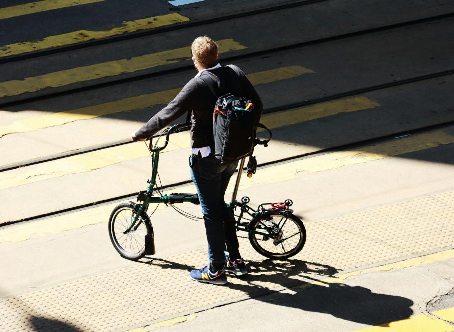 Man with a fold up bike