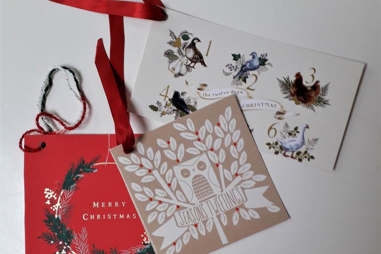 A selection of christmas cards with ribbons attached
