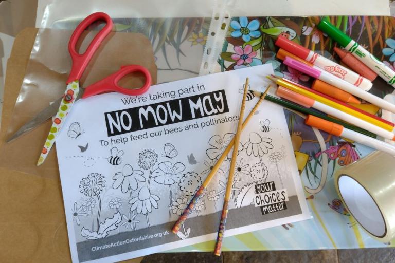 A tray with scissors, paper, colouring pens and sellotape