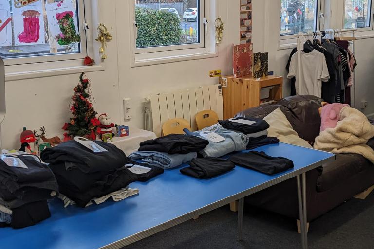maternity clothes of different sizes on a table