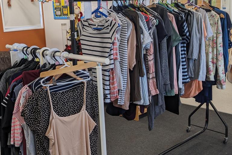 maternity clothes hanging on a clothes rack