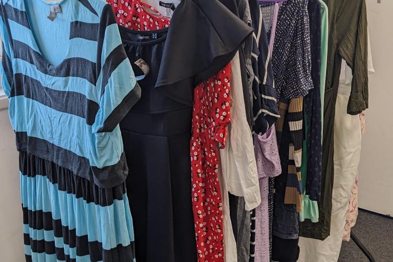 maternity clothes hanging on a clothes rack